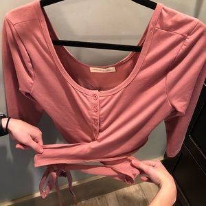 Cropped pink top that ties around the waist